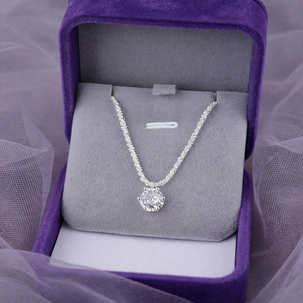 Crown Solitaire necklace in an open purple jewelry box