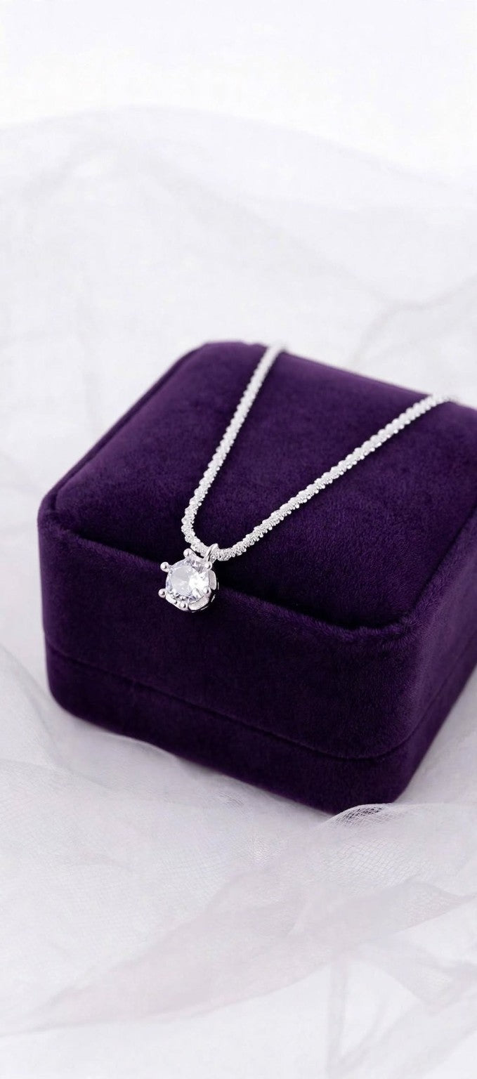 Crown Solitaire necklace on a purple jewelry box