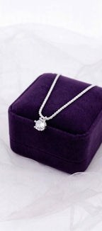 Crown Solitaire necklace on a purple jewelry box