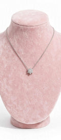 Sunflower CZ necklace on pink display