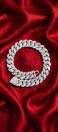 Silver iced-out chain on red satin