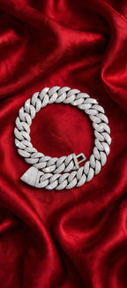 Silver iced-out chain on red satin