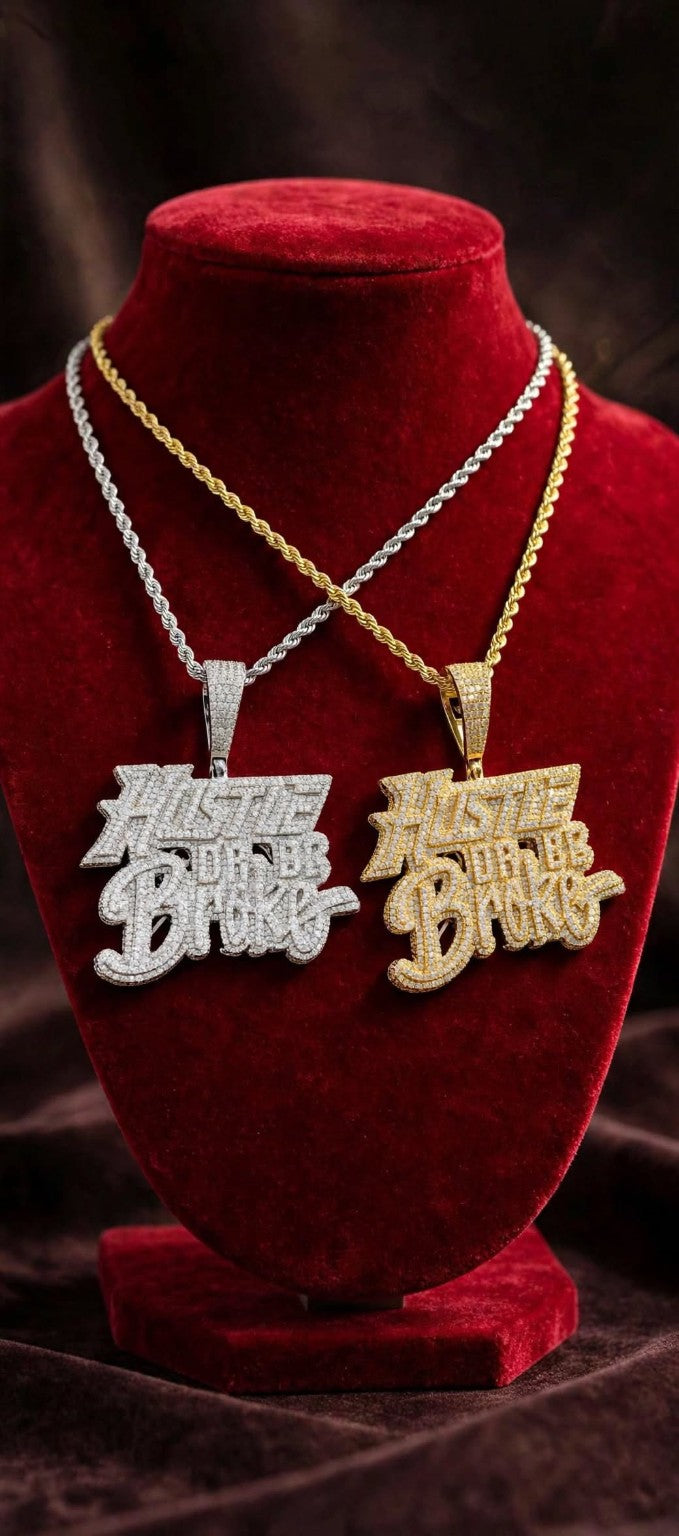 Gold and silver Hustle or Be Broke necklaces on red velvet bust
