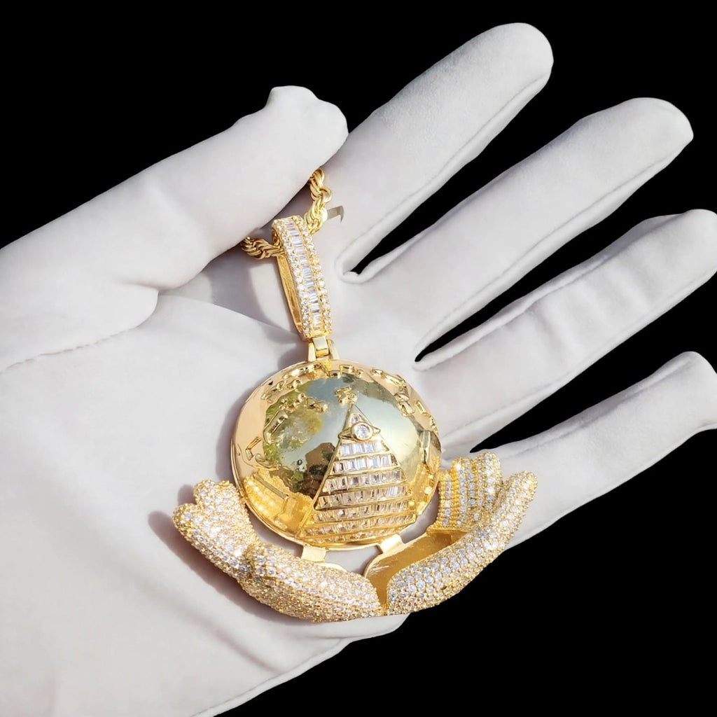 Gold The Architect pendant on a white glove