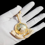 Gold The Architect pendant on a white glove