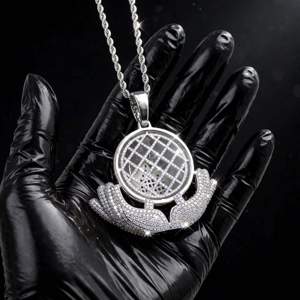 Silver The Architect pendant in a black-glove close-up