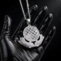 Silver The Architect pendant in a black-glove close-up
