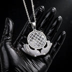 Silver The Architect pendant in a black-glove close-up