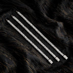 Three bracelet lengths on black fabric