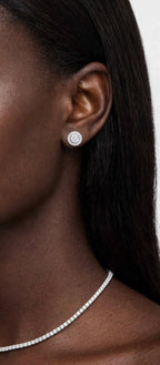 Model wearing round halo stud earrings; necklace shown separately
