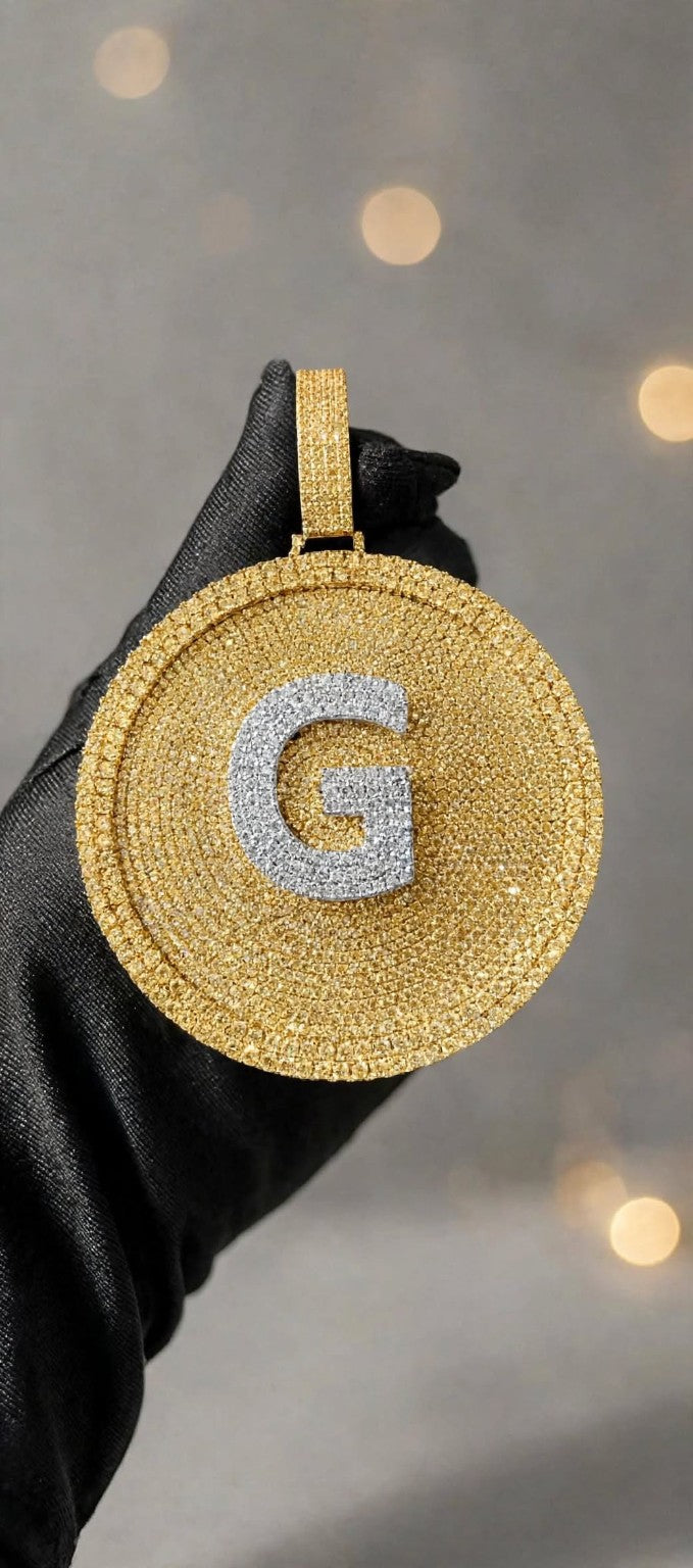 Gold iced-out disc pendant with silver G