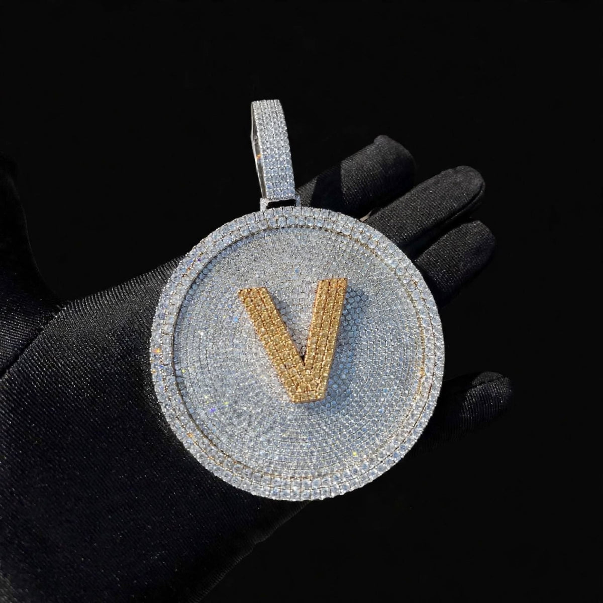 Silver iced-out disc pendant with gold V