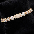 Gold cluster tennis bracelet showing halo settings and iced box clasp