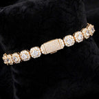Gold cluster tennis bracelet showing halo settings and iced box clasp