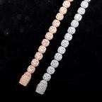 Rose gold and silver cluster tennis bracelets on black background