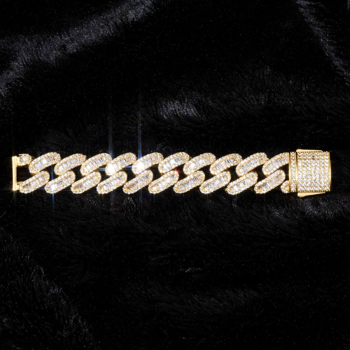 The Diplomat gold bracelet laid flat on black fabric