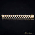 The Diplomat gold bracelet laid flat on a black reflective surface