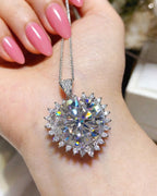 White pendant held in hand