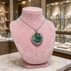 Green pendant on pink velvet display