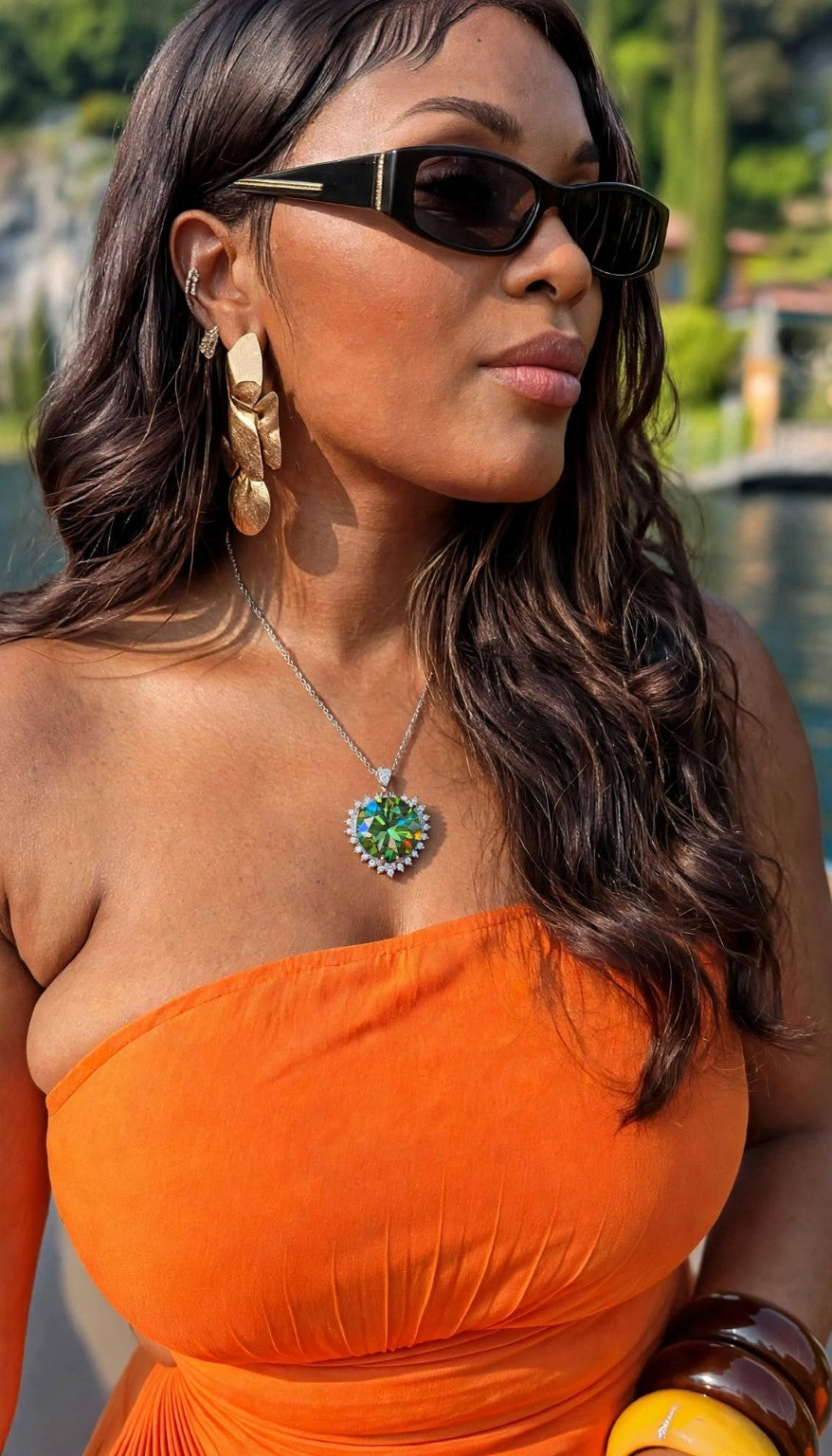 Green pendant worn with orange dress