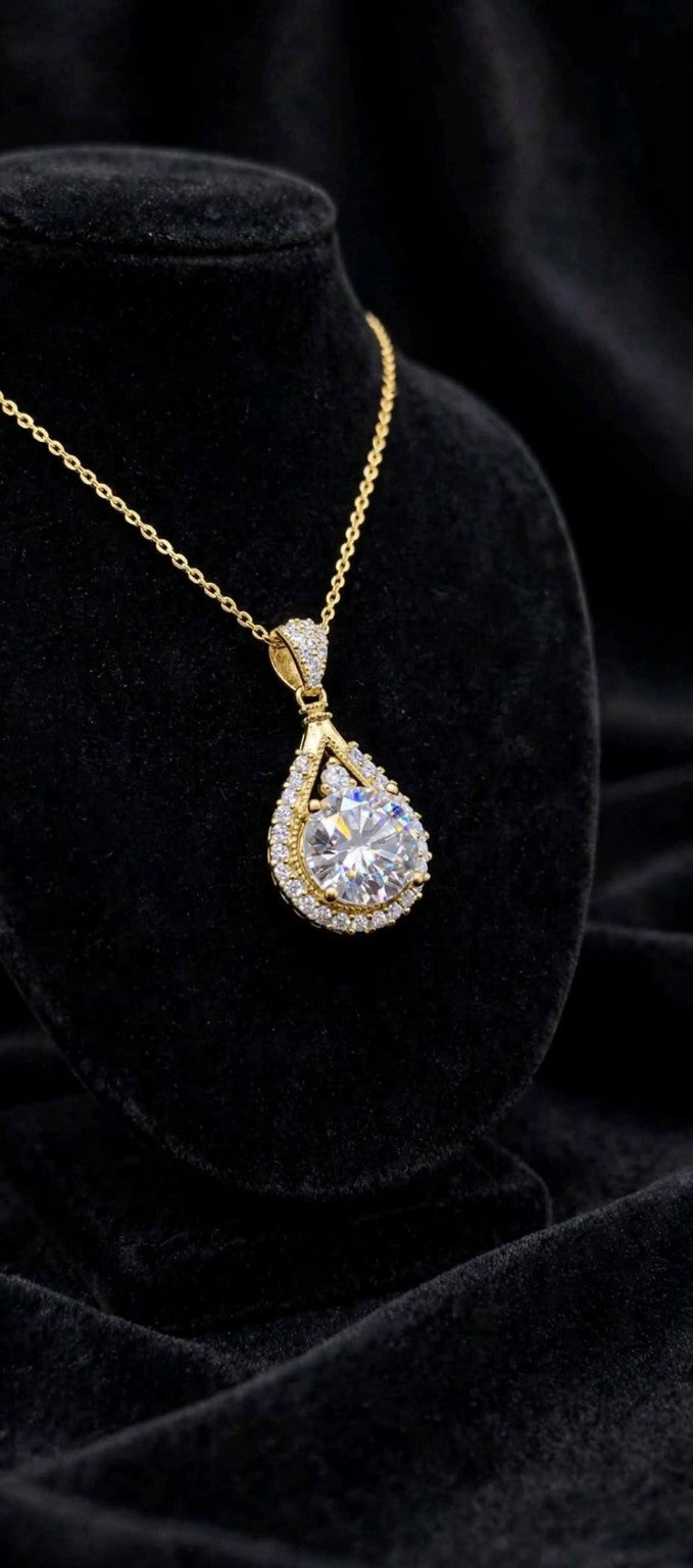 The Empress Teardrop necklace in gold finish on black velvet