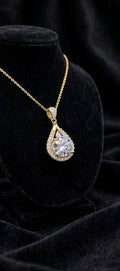 The Empress Teardrop necklace in gold finish on black velvet