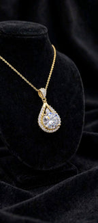 The Empress Teardrop necklace in gold finish on black velvet
