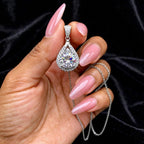 The Empress Teardrop necklace in white finish held in hand