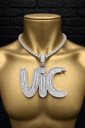The Graveyard Shift custom iced-out VIC pendant on a gold mannequin, front view