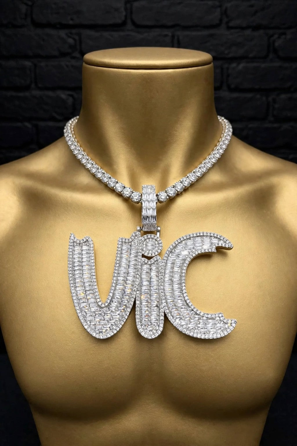 The Graveyard Shift custom iced-out VIC pendant on a gold mannequin, front view