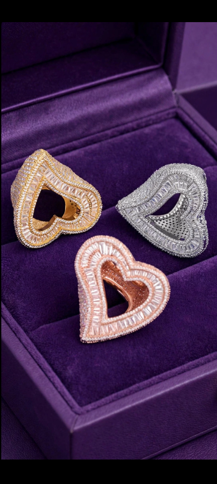 Gold, silver, and rose gold finish open heart rings in a purple jewelry box