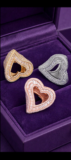 Gold, silver, and rose gold finish open heart rings in a purple jewelry box