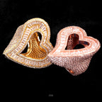 Gold and rose gold finish open heart rings on black velvet