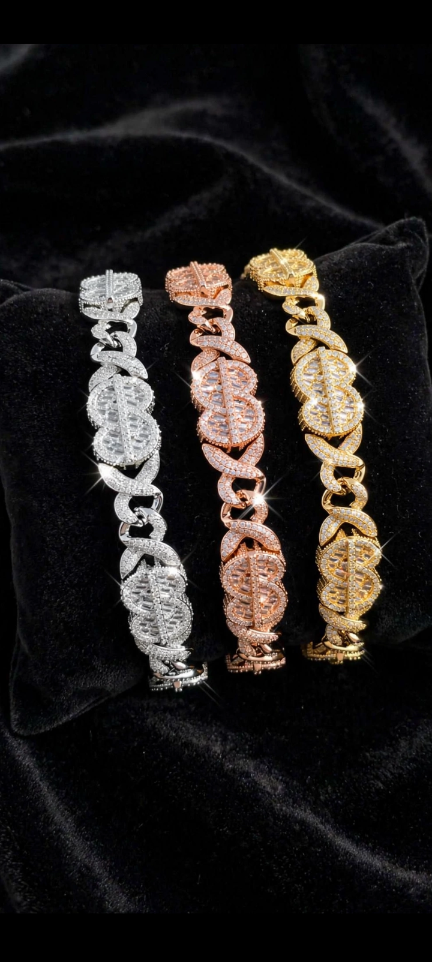 Silver rose gold and gold iced statement bracelets displayed on black velvet