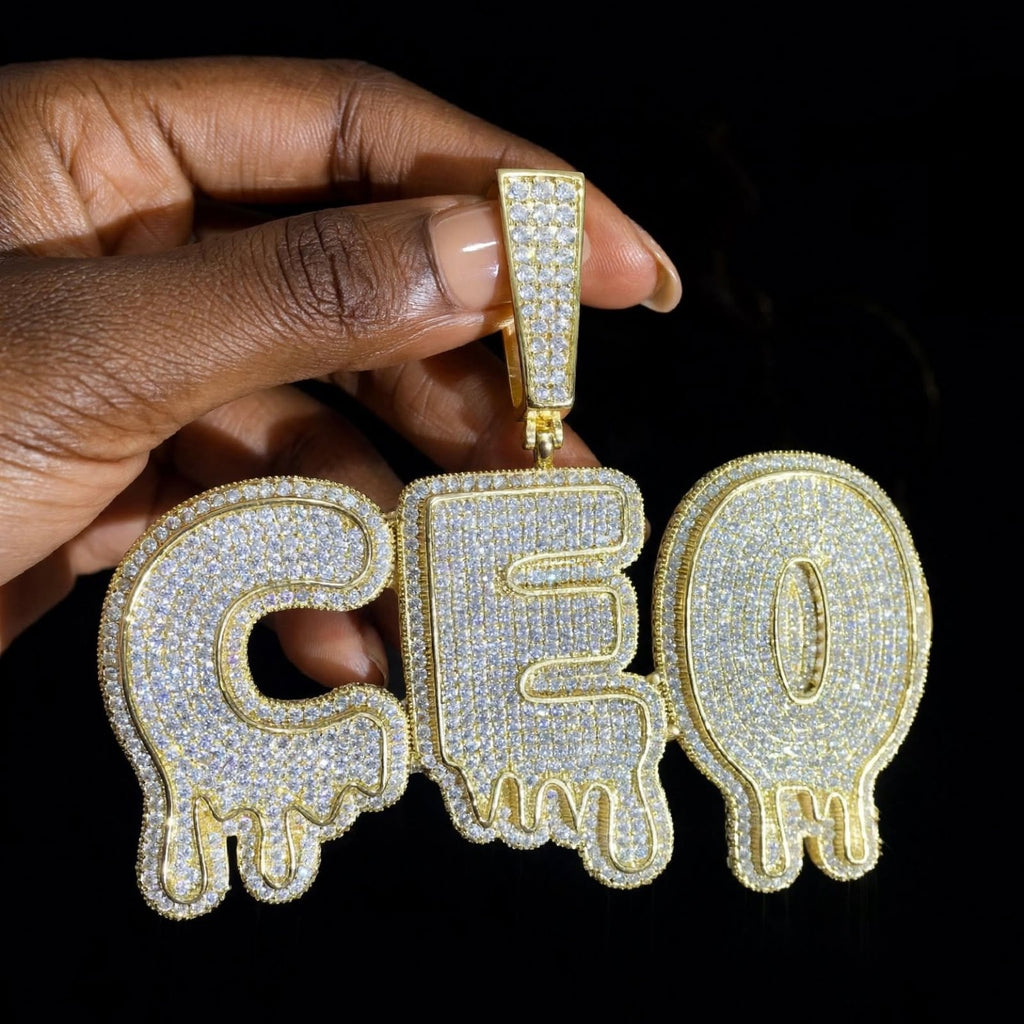 The Drip custom gold iced-out CEO pendant, straight-on front hero photograph