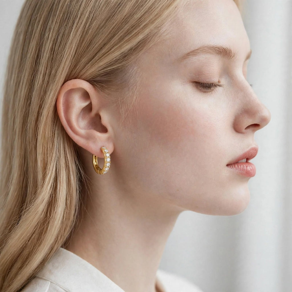 Model wearing a gold finish Nfiniti Radiance moissanite hoop earring