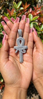 Silver iced ankh pendant with Eye of Horus detail held in hands