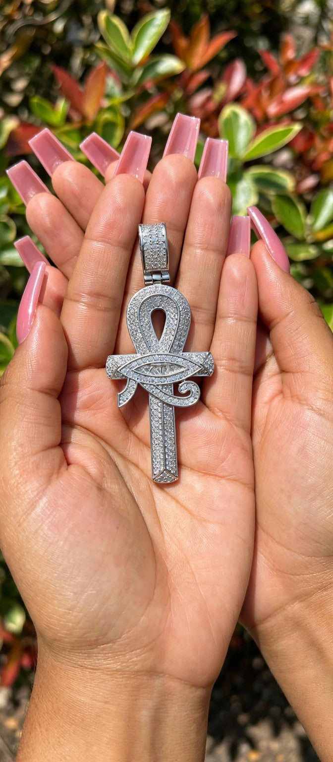 Silver iced ankh pendant with Eye of Horus detail held in hands