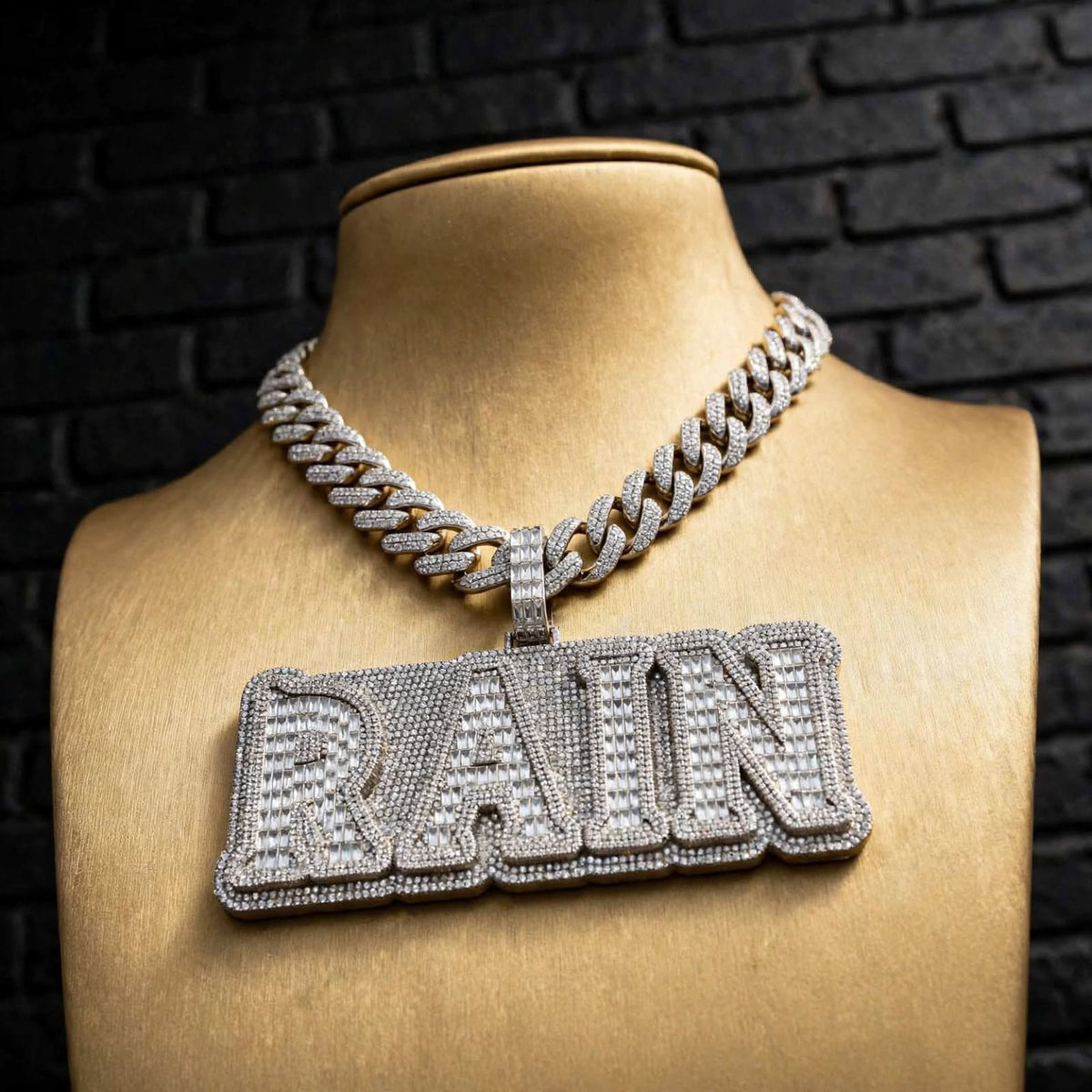 RAIN custom pendant close-up on gold display bust