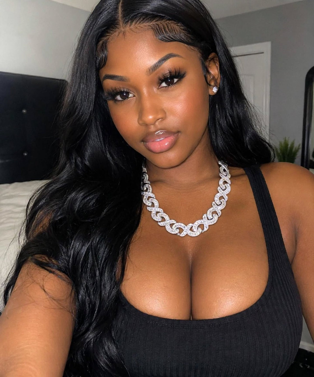 Model wearing platinum tone infinity-link chain