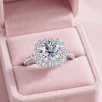 The Royal Promise white gold-filled halo ring on pink velvet