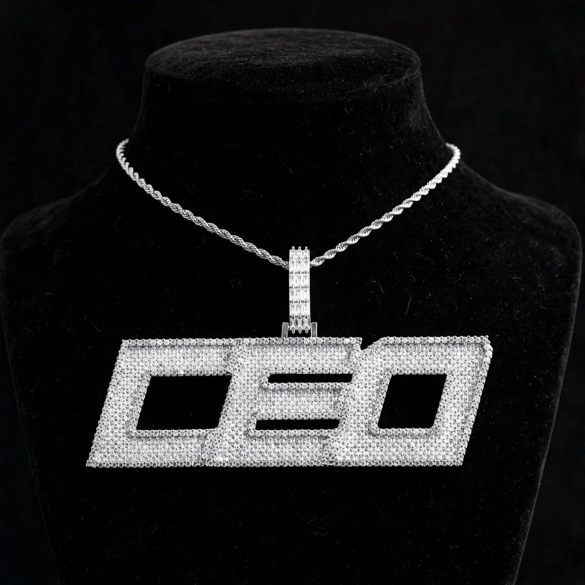 Silver-color DEO iced-out custom pendant on black velvet bust