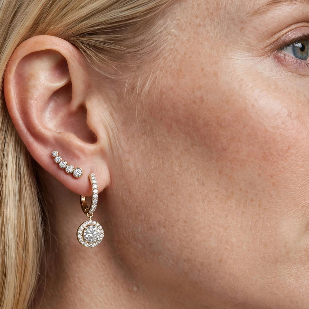 Gold-tone moissanite dangle earring worn by model