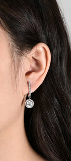 Silver-tone moissanite dangle earring worn by model