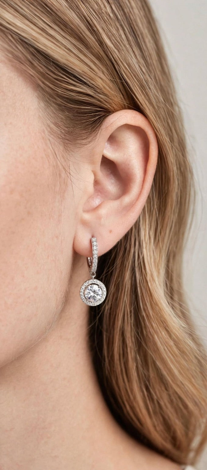 Close-up of silver-tone moissanite dangle earring