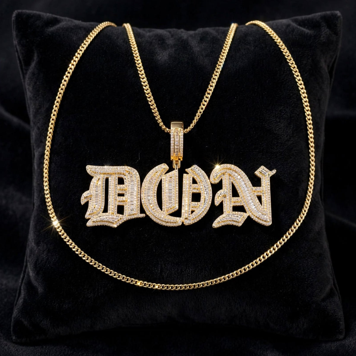 Gold Old English DON custom pendant with chain displayed on black velvet