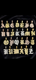 Gold Old English initial pendant on black velvet with iced-out Cuban chain