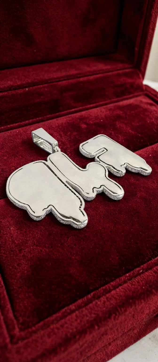 The Drip custom pendant smooth reverse in silver finish on red velvet, with iced edges