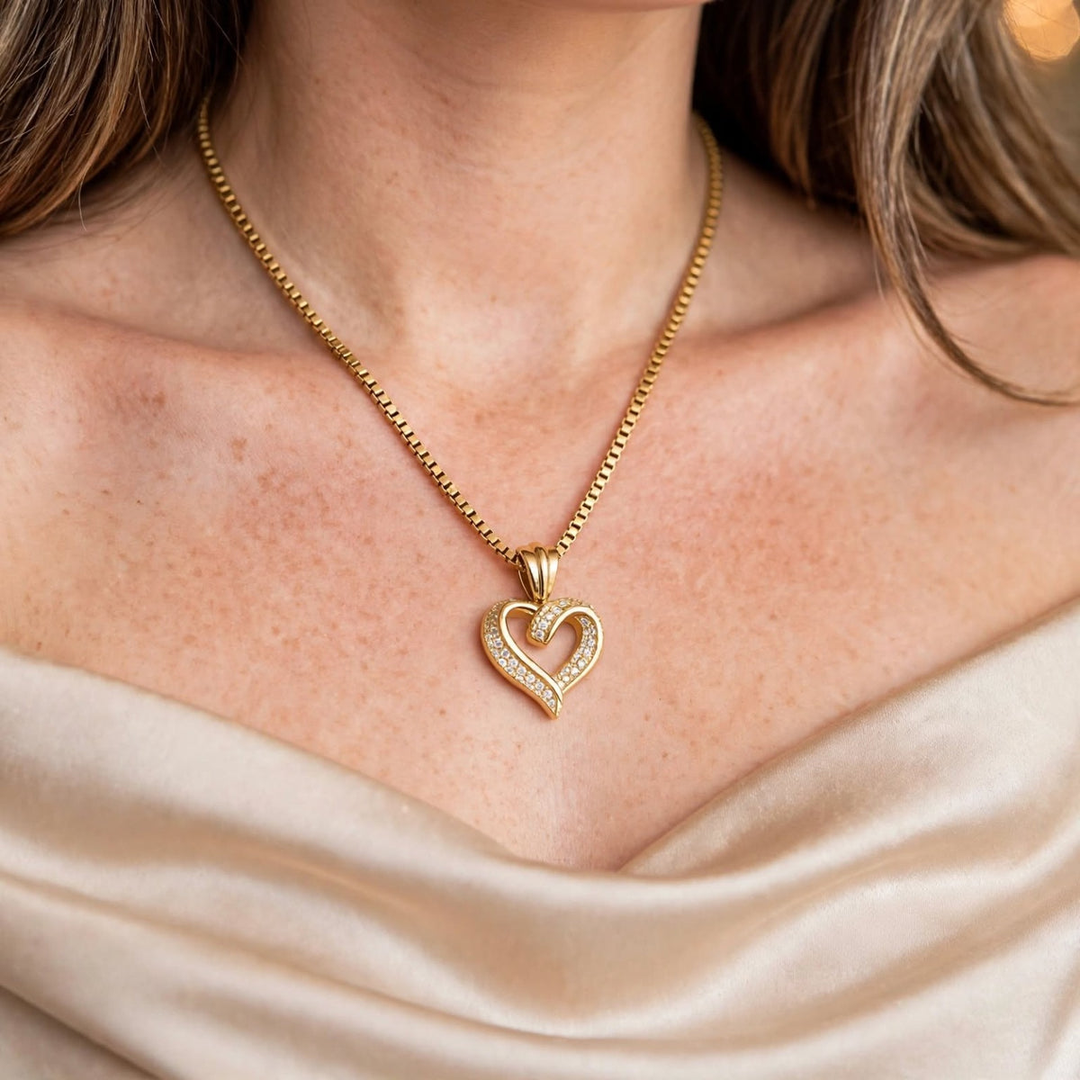 The Golden Embrace gold-tone heart necklace worn with ivory blouse