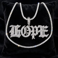 Silver Old English HOPE iced-out baguette pendant with tennis chain displayed on black velvet